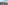 Panoramic Madrid cityscape with red tile rooftops, church spires, and blue sky.