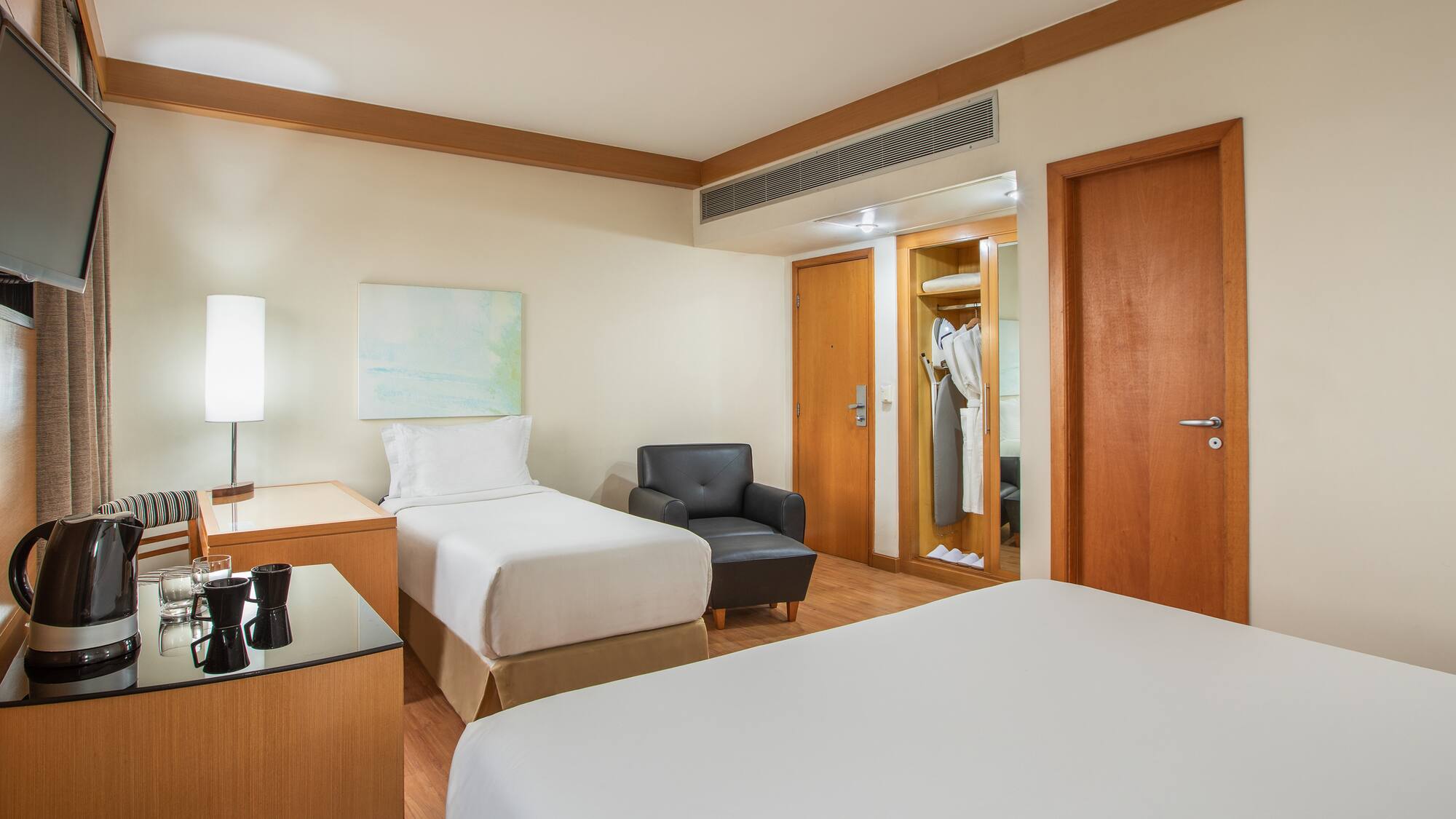 a room with two beds and a chair