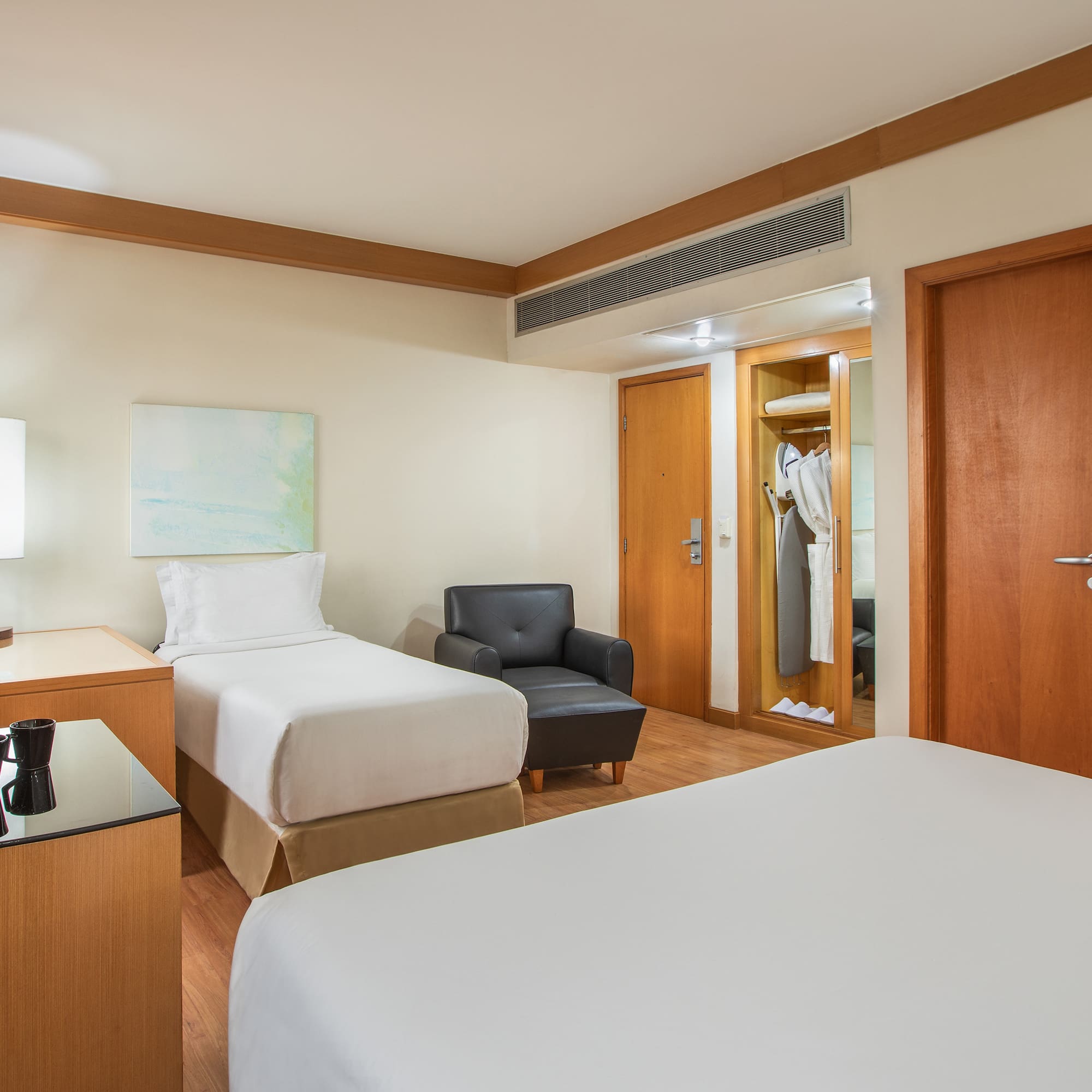 a room with two beds and a chair