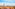 a city with satellite dishes and mountains in the background