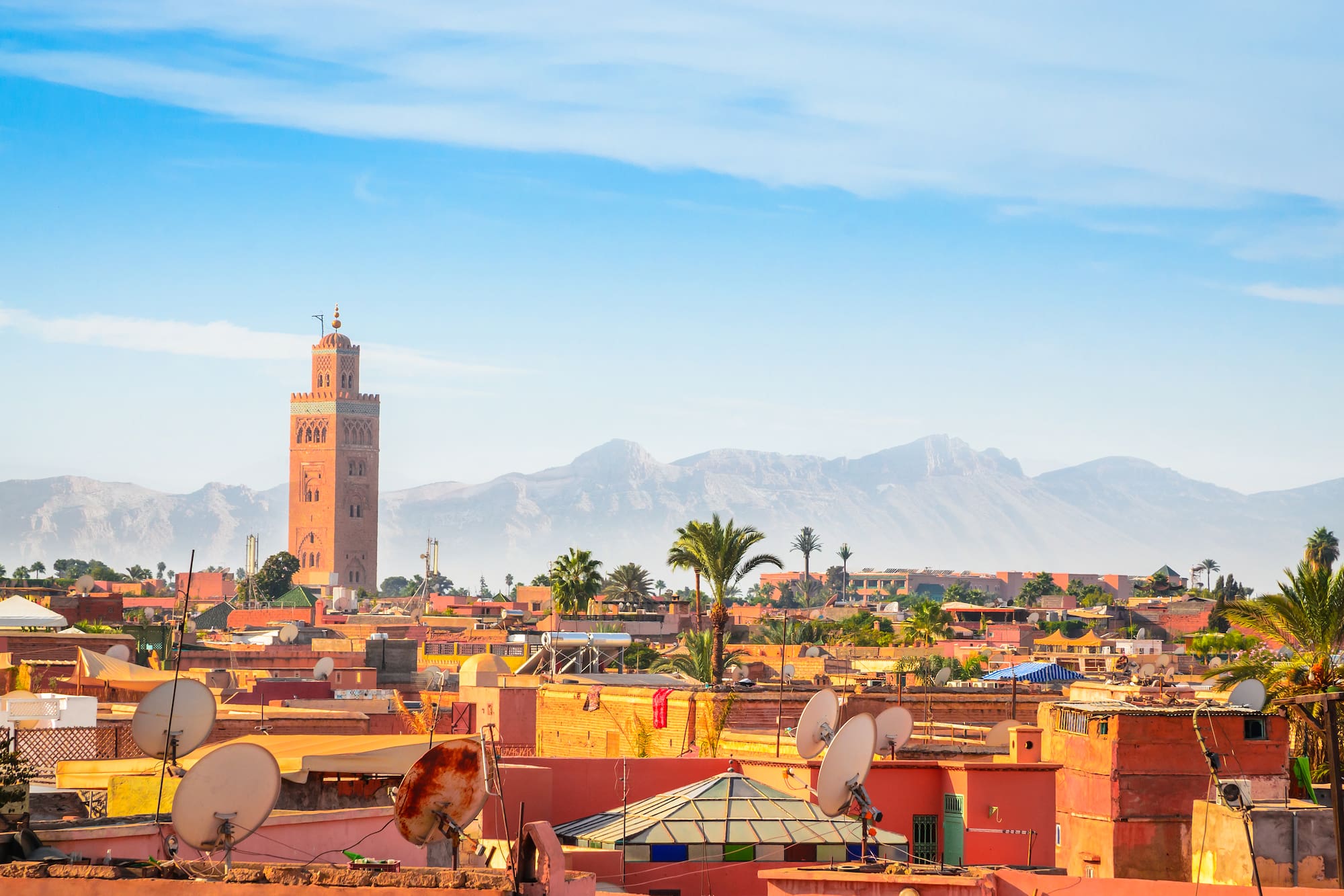 a city with satellite dishes and mountains in the background