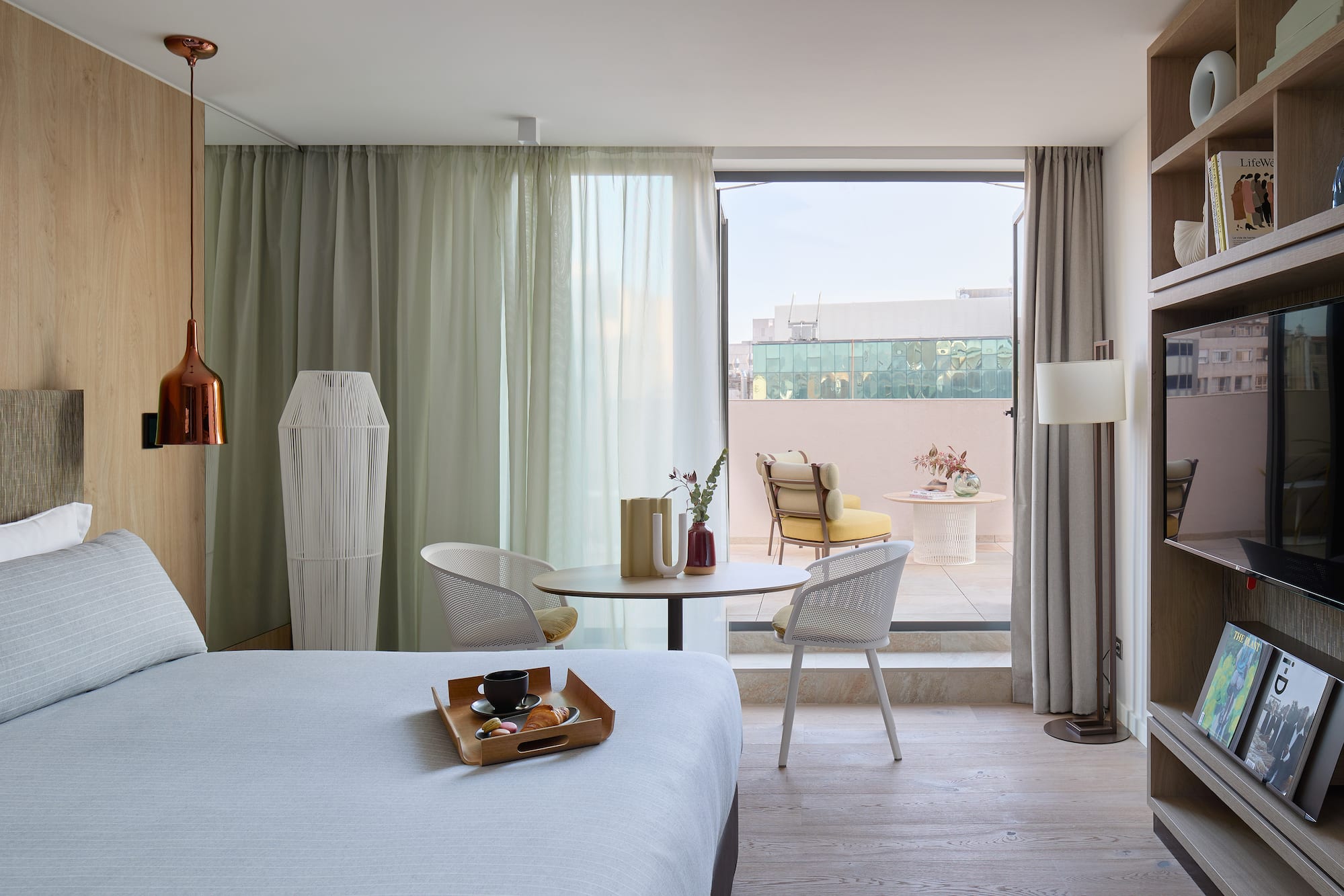 a room with a bed and a table and chairs