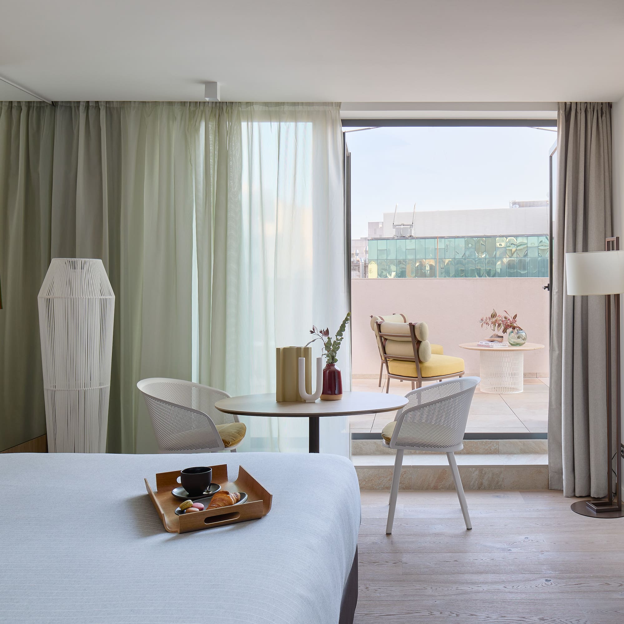 a room with a bed and a table and chairs