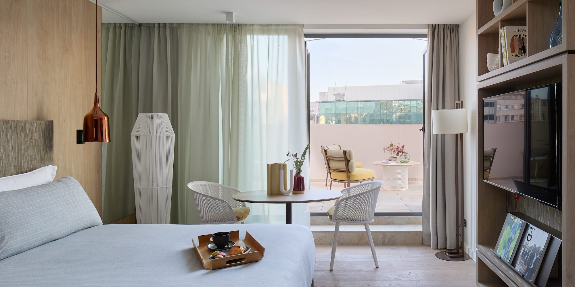 a room with a bed and a table and chairs