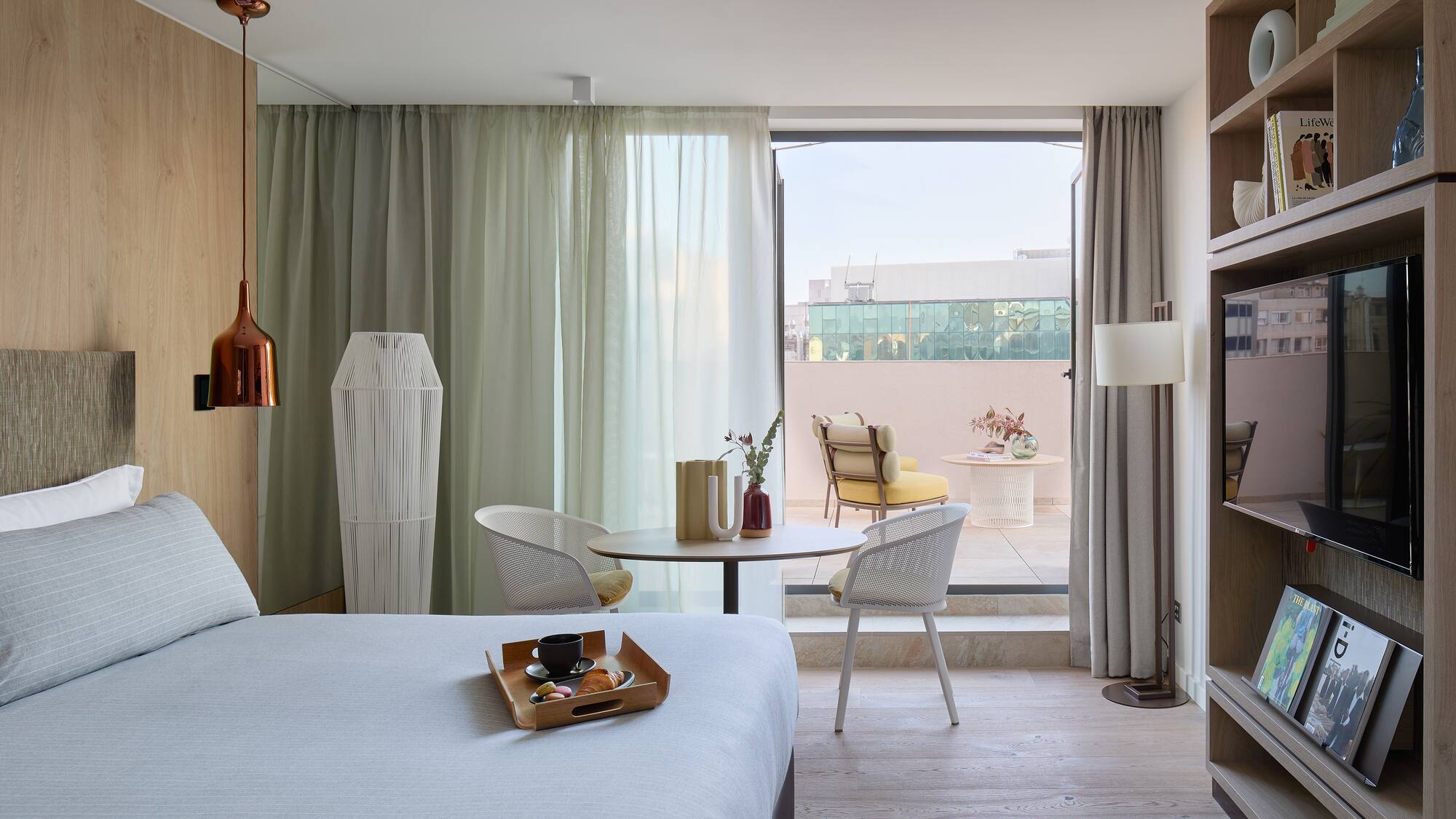 a room with a bed and a table and chairs