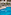 Hotel outdoor swimming pool, sun loungers, palm trees, and modern building.