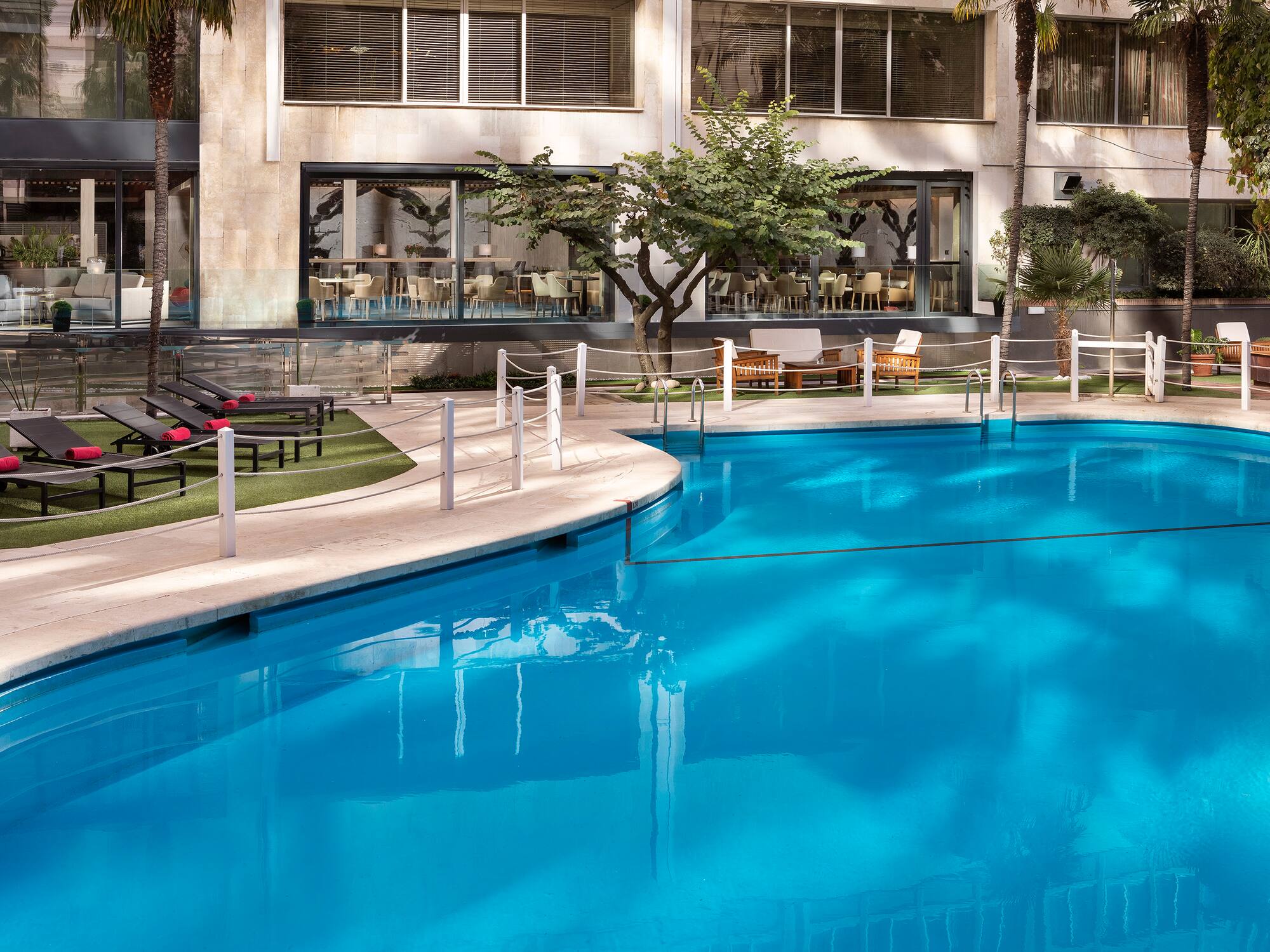 a swimming pool with a building in the background