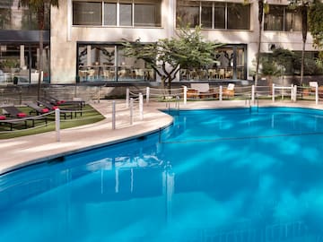 a swimming pool with a building in the background