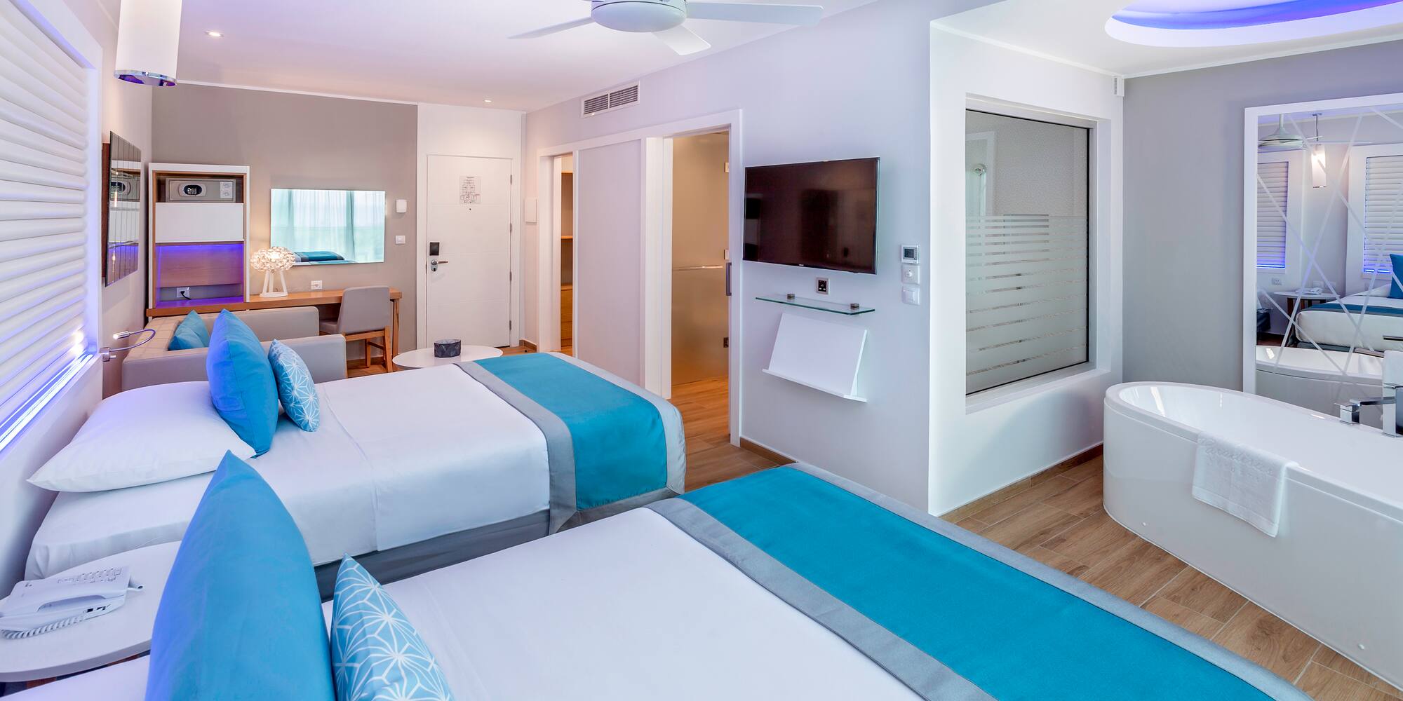 a room with two beds and a tub