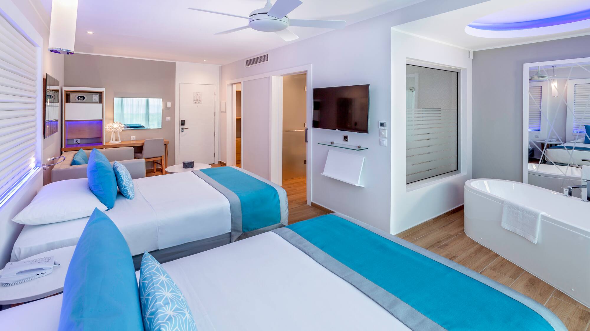 a room with two beds and a tub