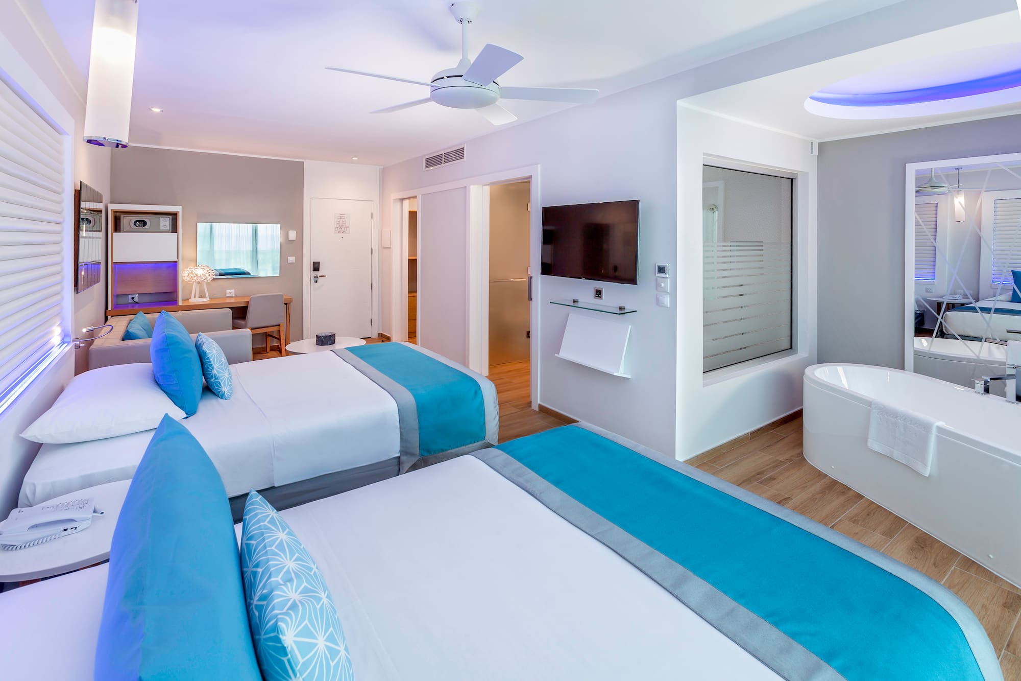 a room with two beds and a tub