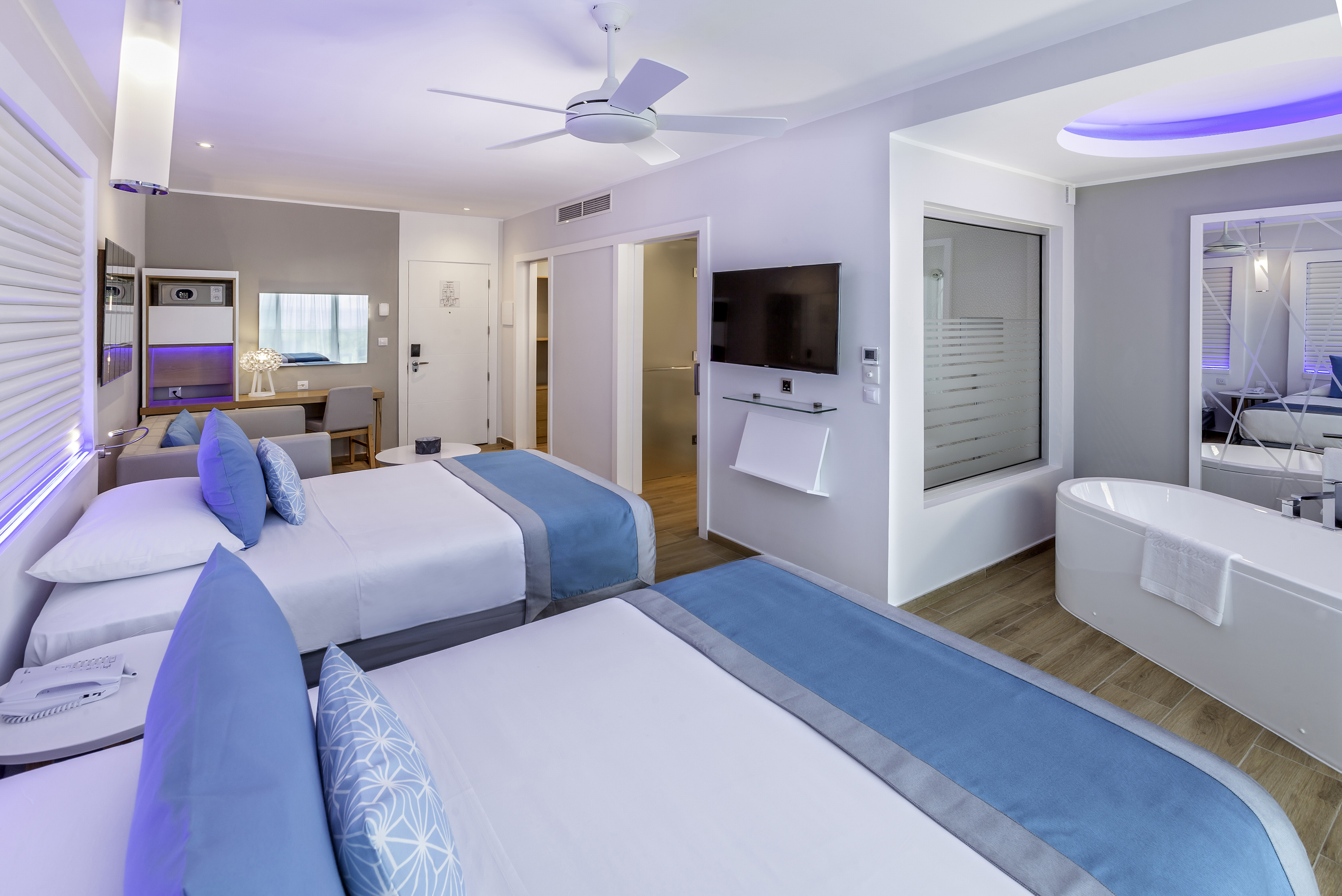 a room with two beds and a tub