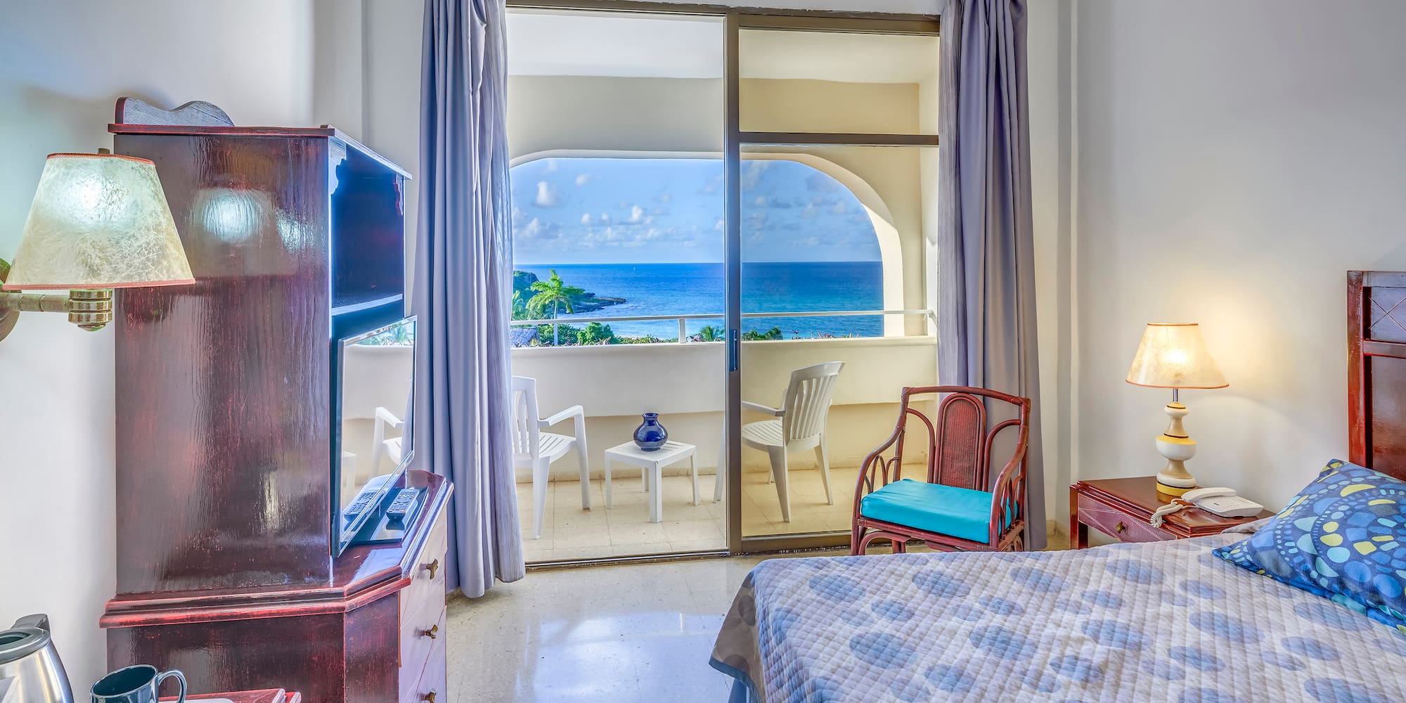 a bedroom with a view of the ocean
