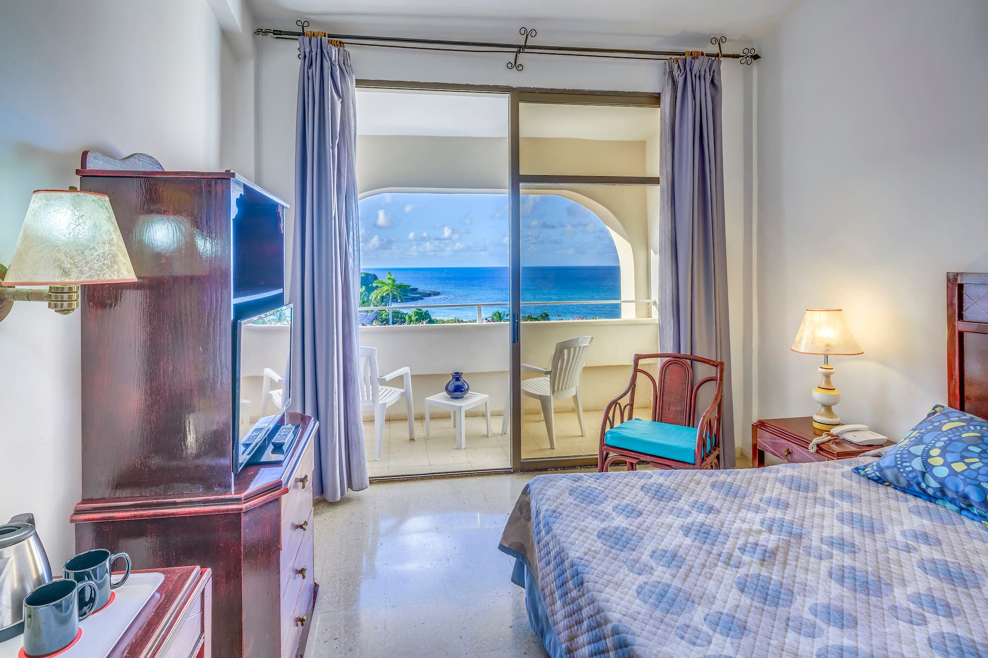 a bedroom with a view of the ocean
