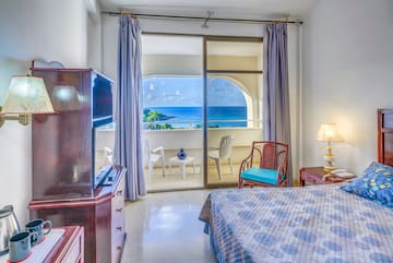 a bedroom with a view of the ocean