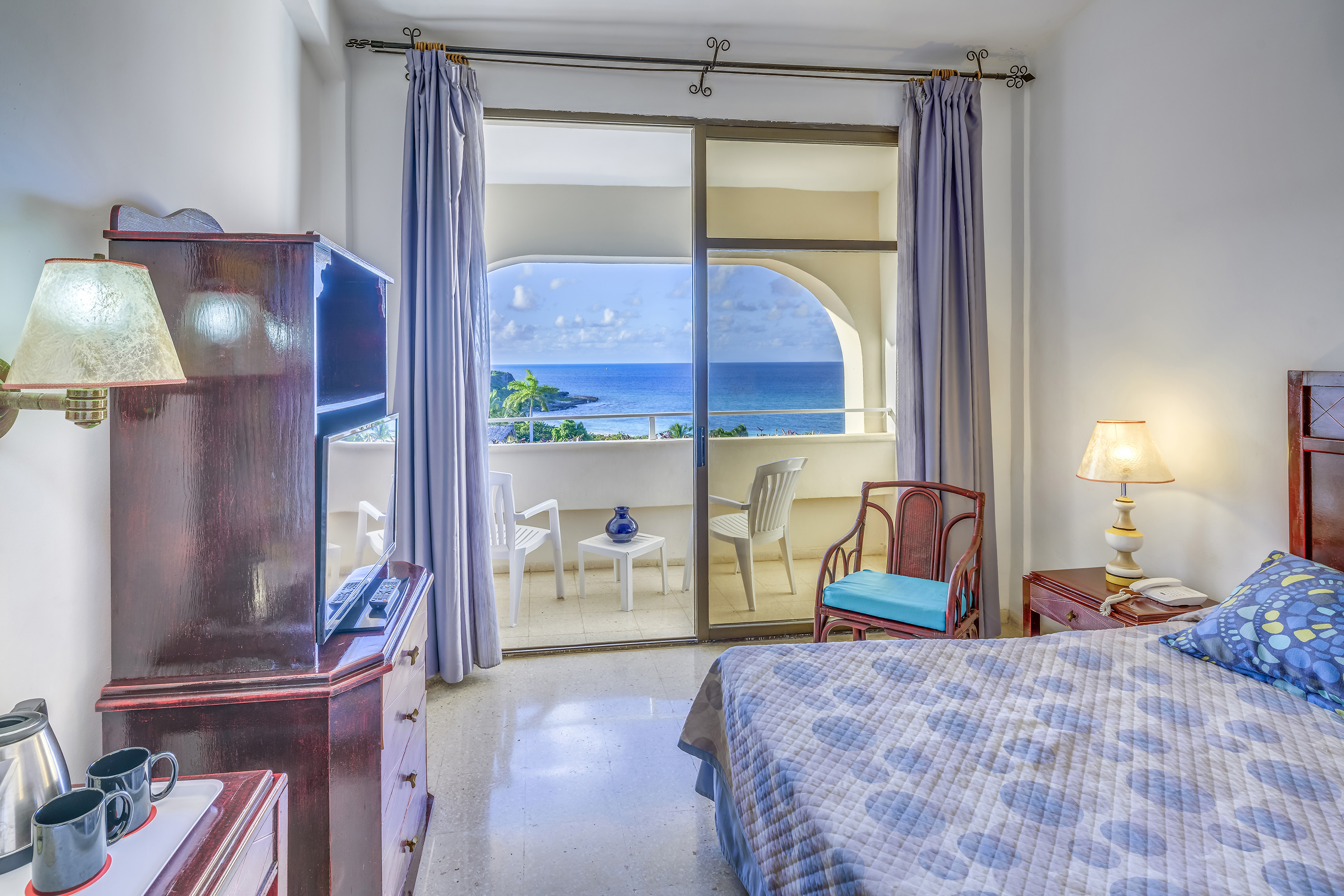 a bedroom with a view of the ocean