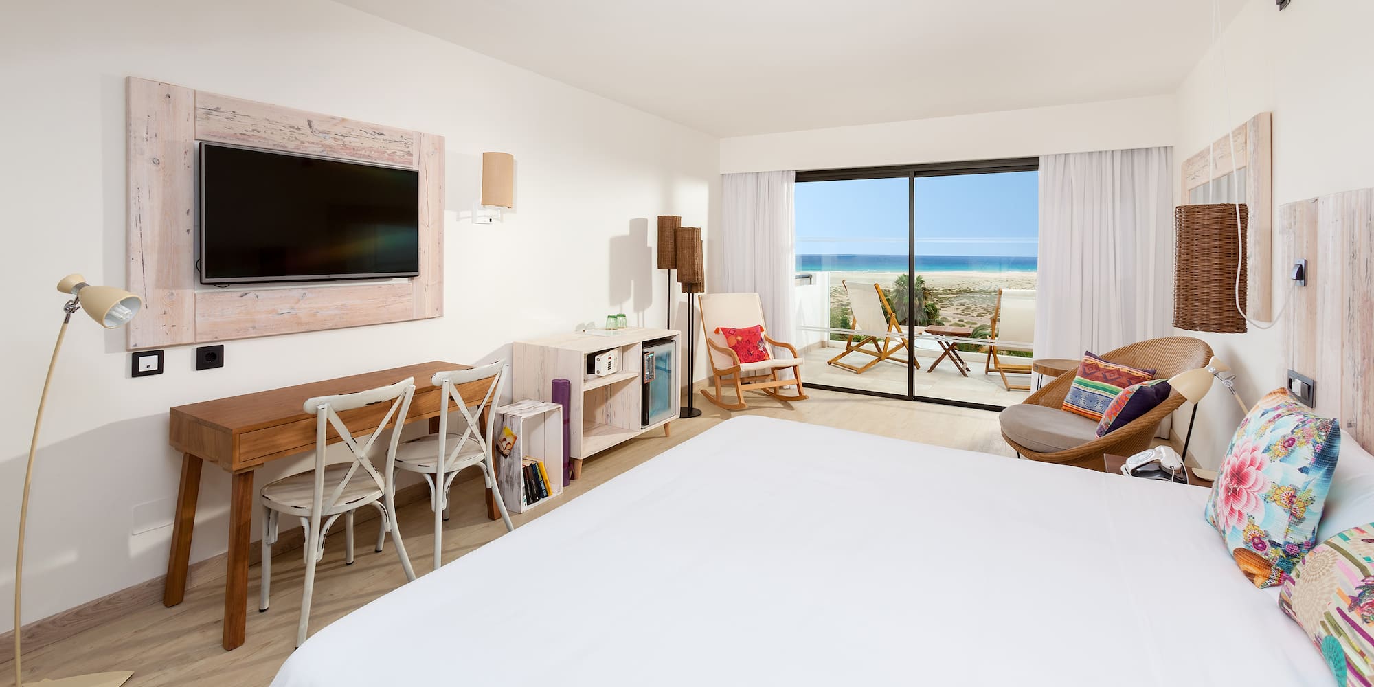 a bedroom with a television and a large window