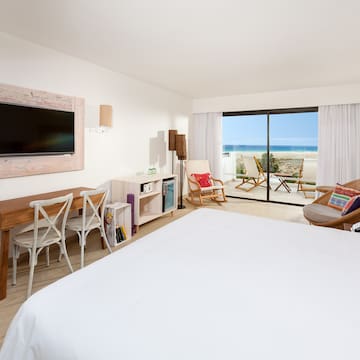 a bedroom with a television and a large window