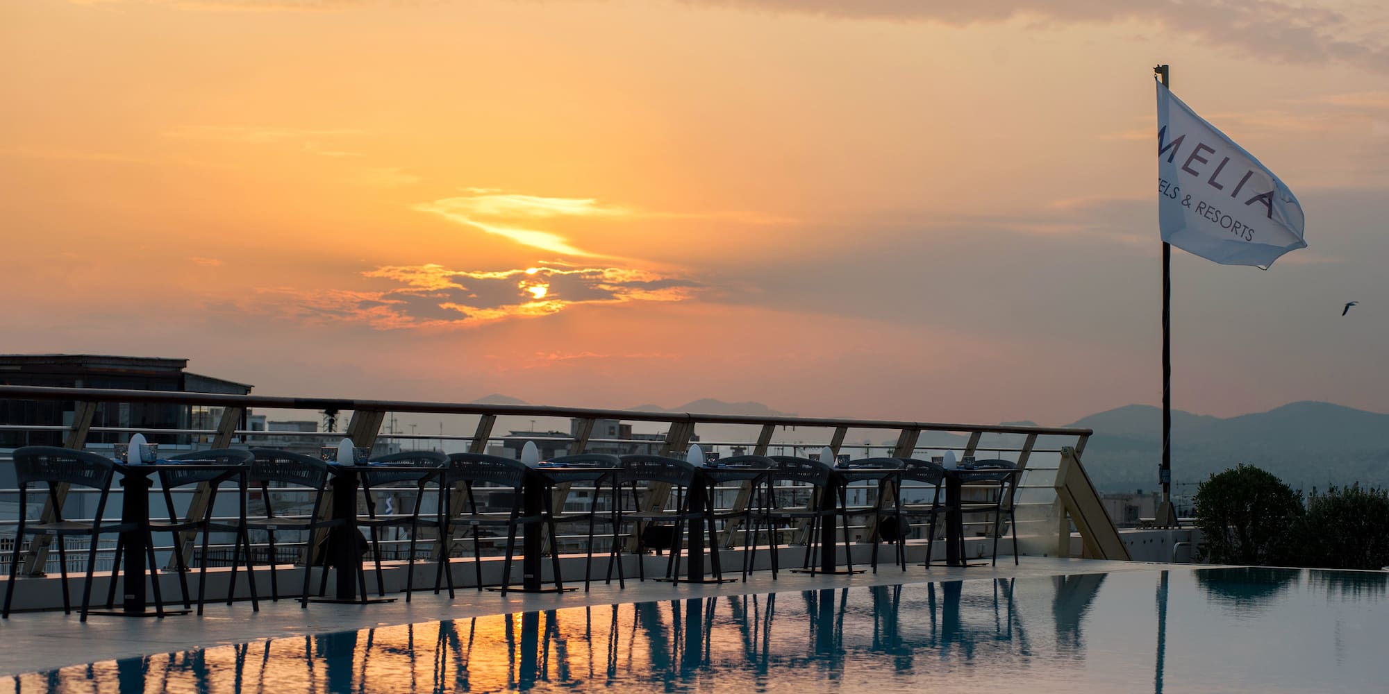 a pool with chairs and tables on it