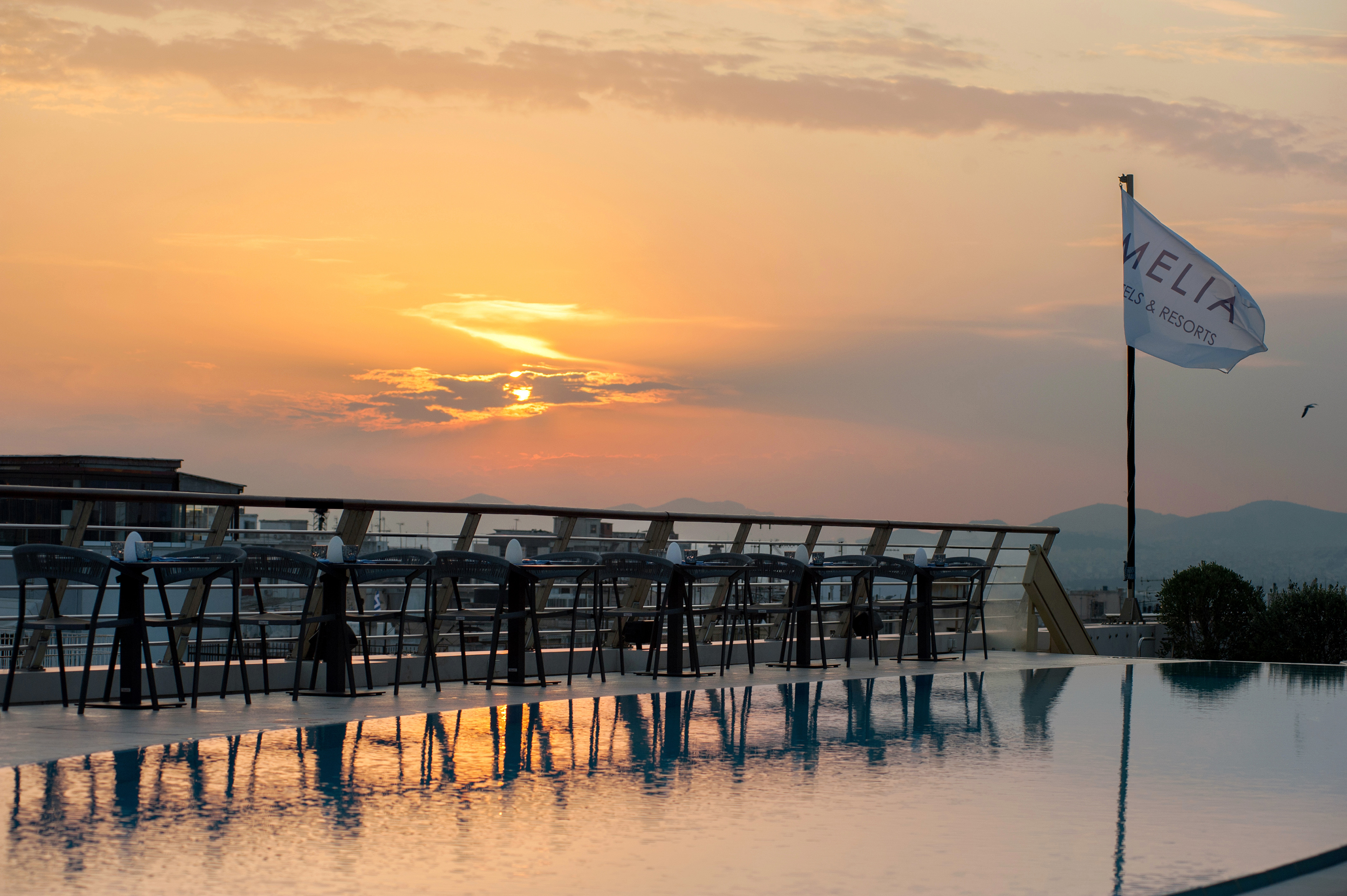 a pool with chairs and tables on it