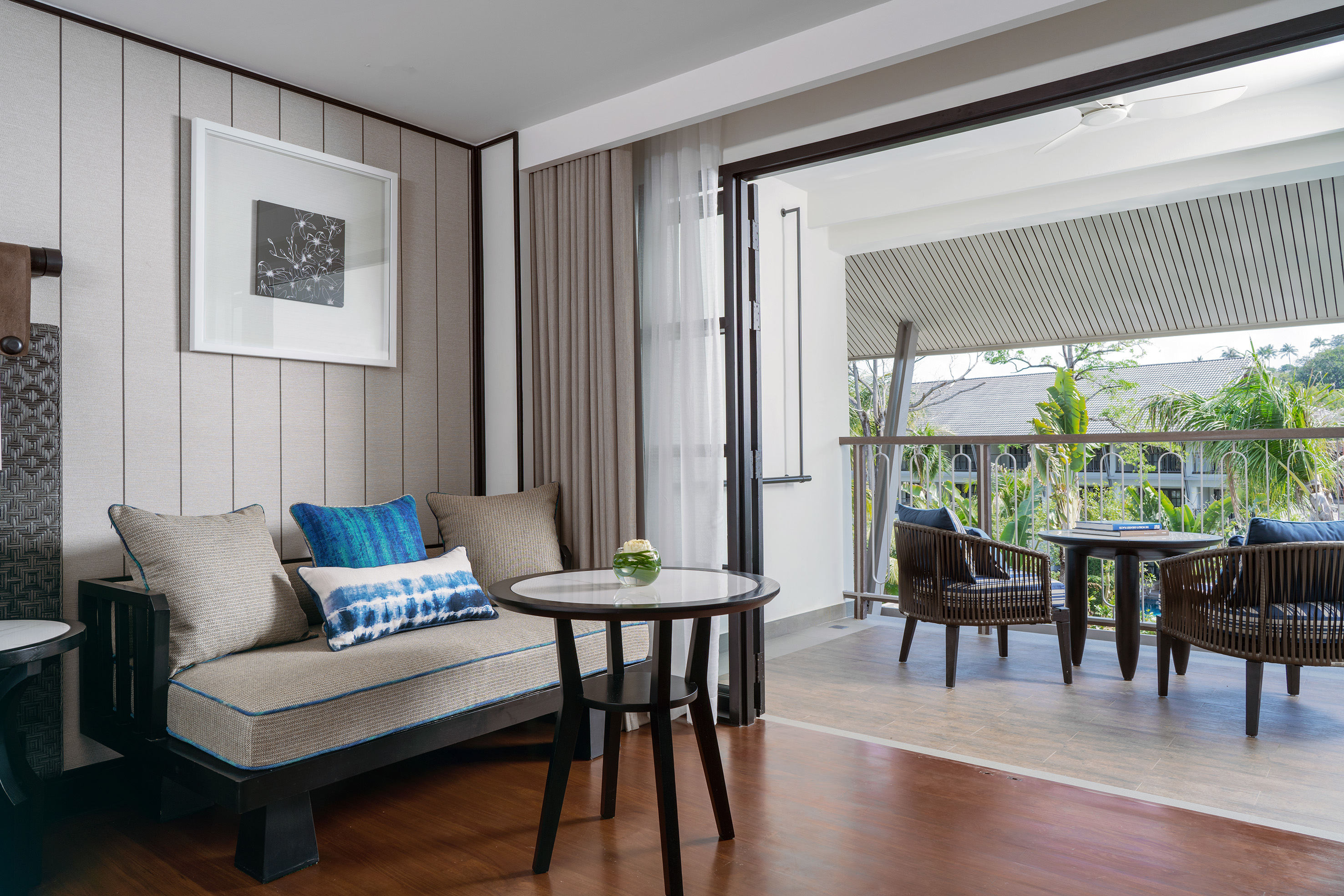 Tropical resort suite living room with balcony.