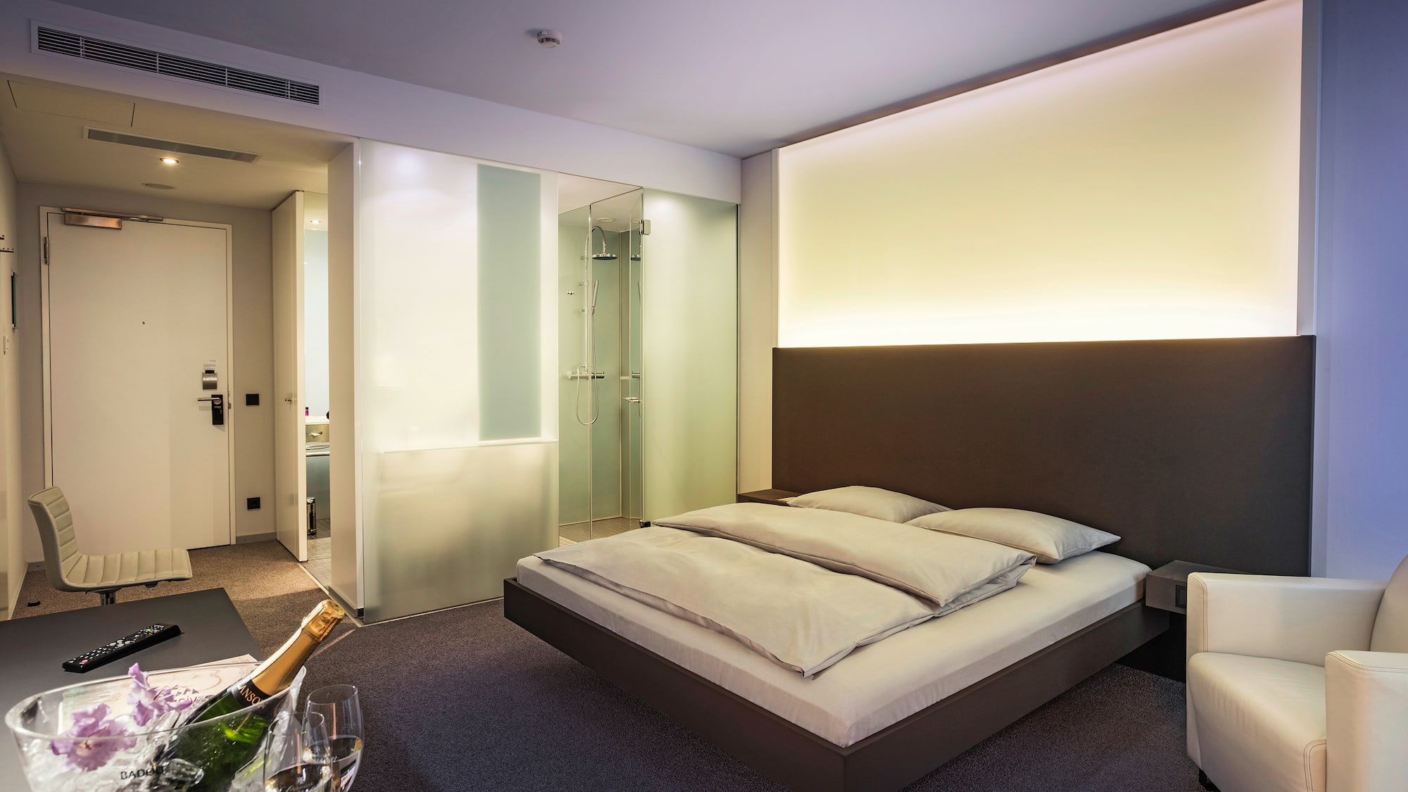 a bedroom with a glass of champagne