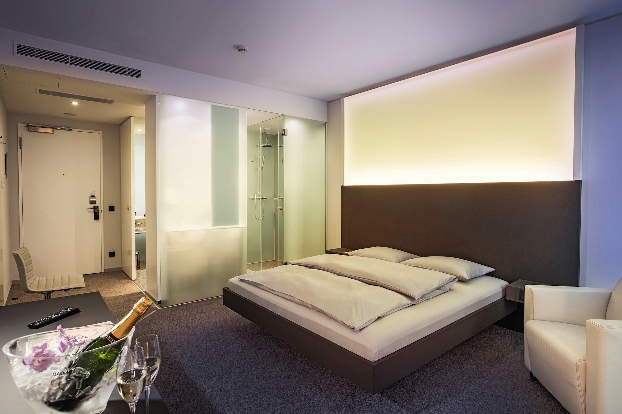 a bedroom with a glass of champagne