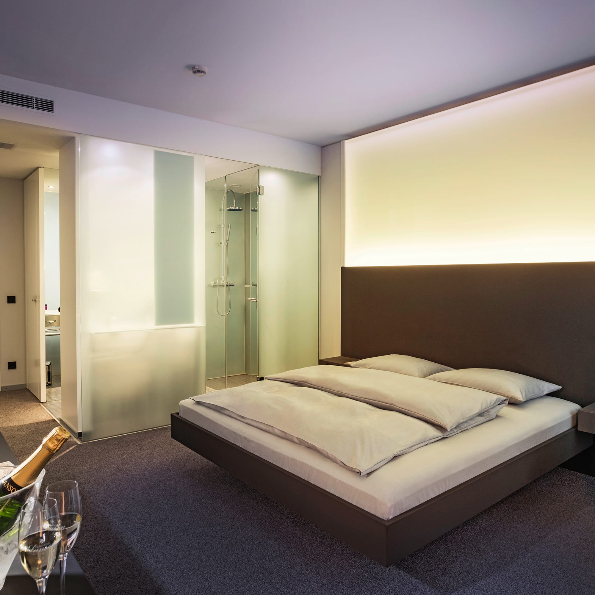 a bedroom with a glass of champagne