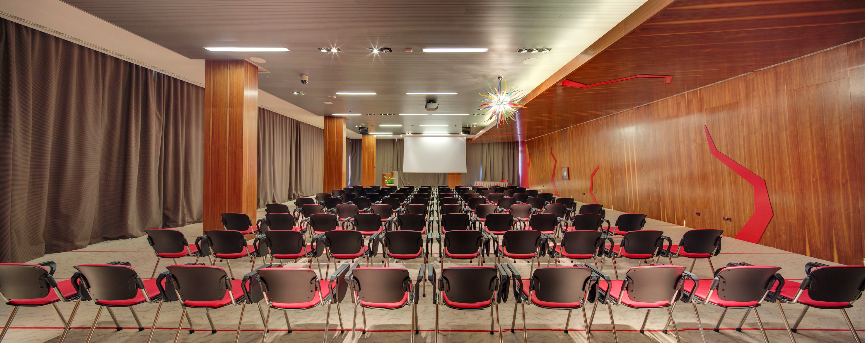 a room with many chairs and a projector screen