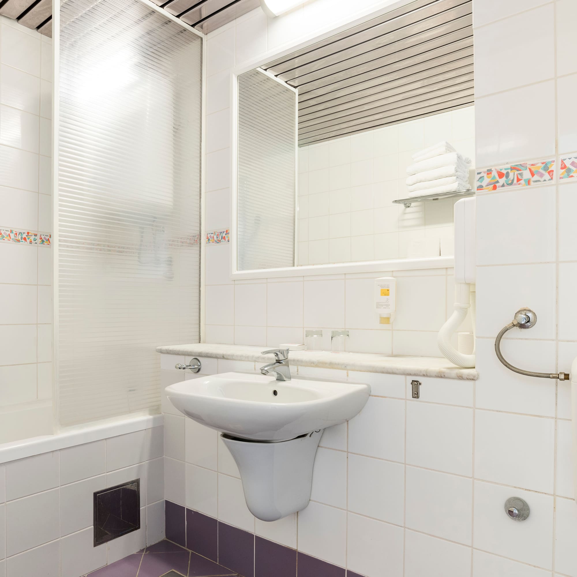 a bathroom with a sink and mirror