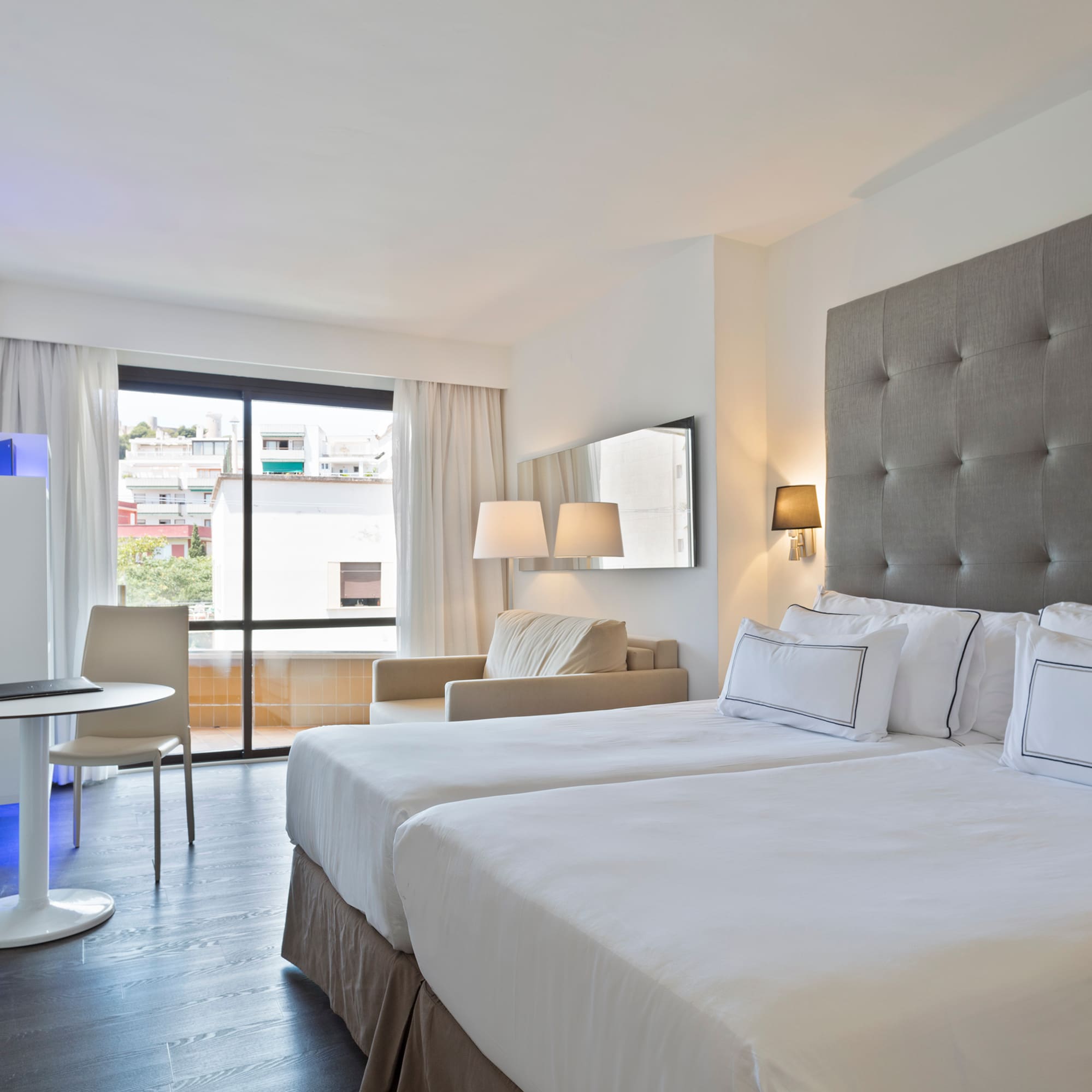 a room with two beds and a table