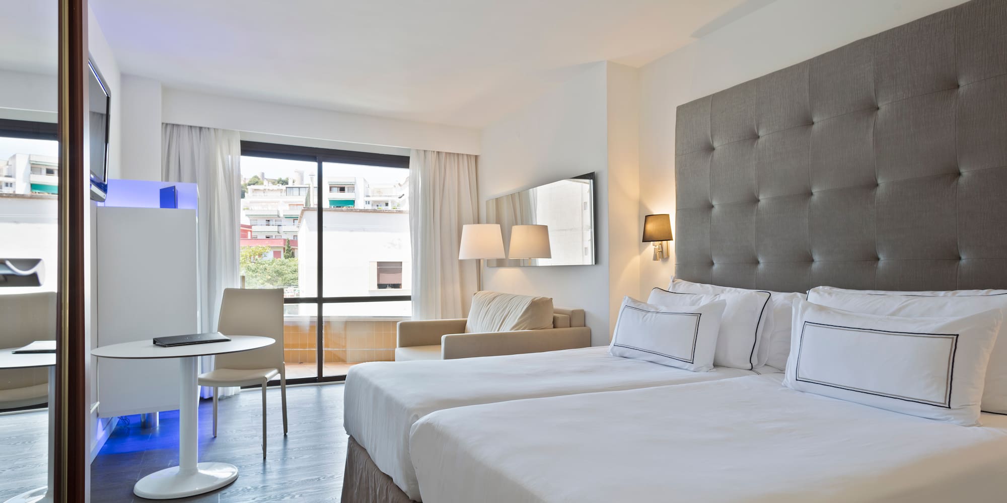 a room with two beds and a table