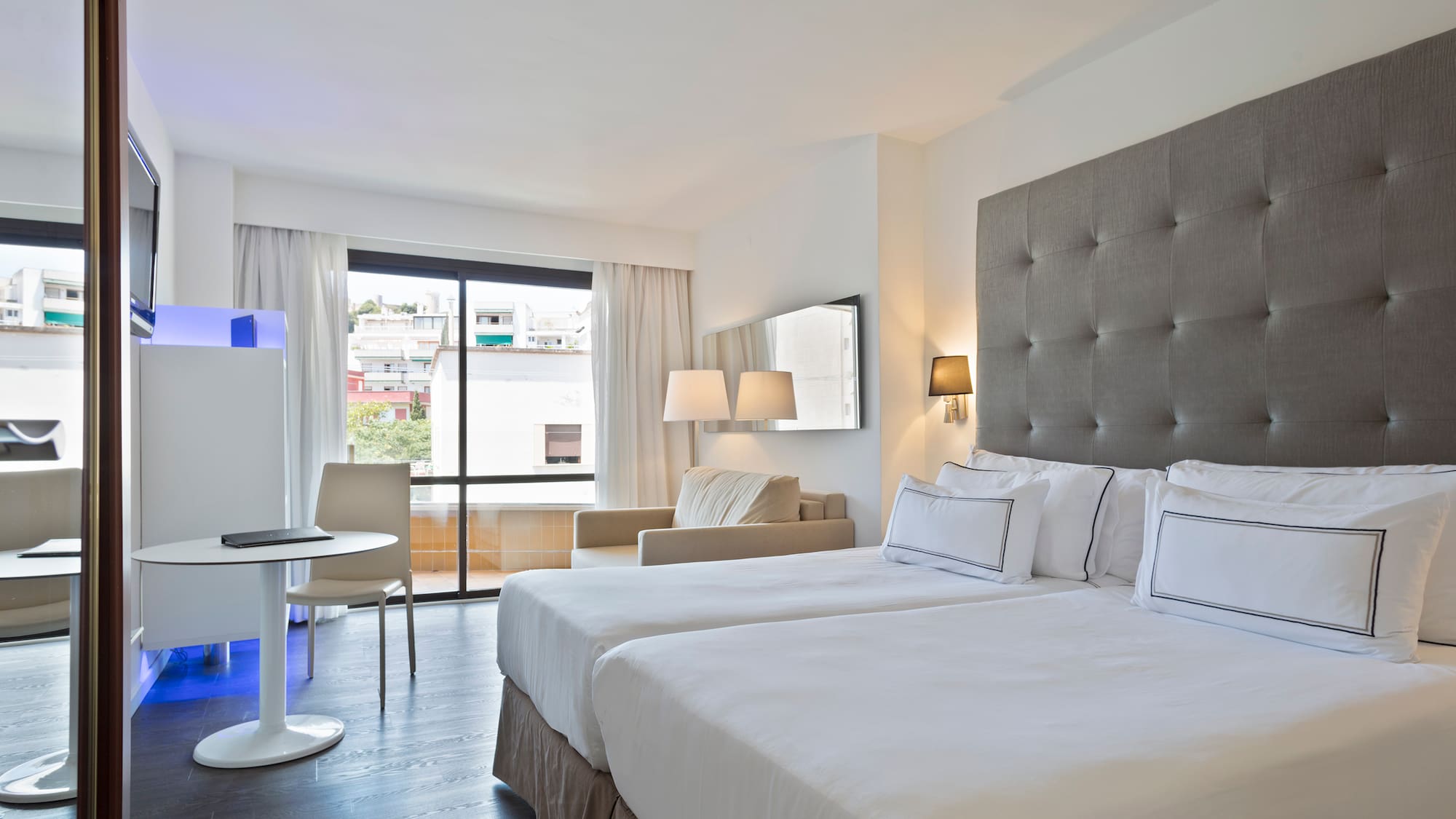 a room with two beds and a table