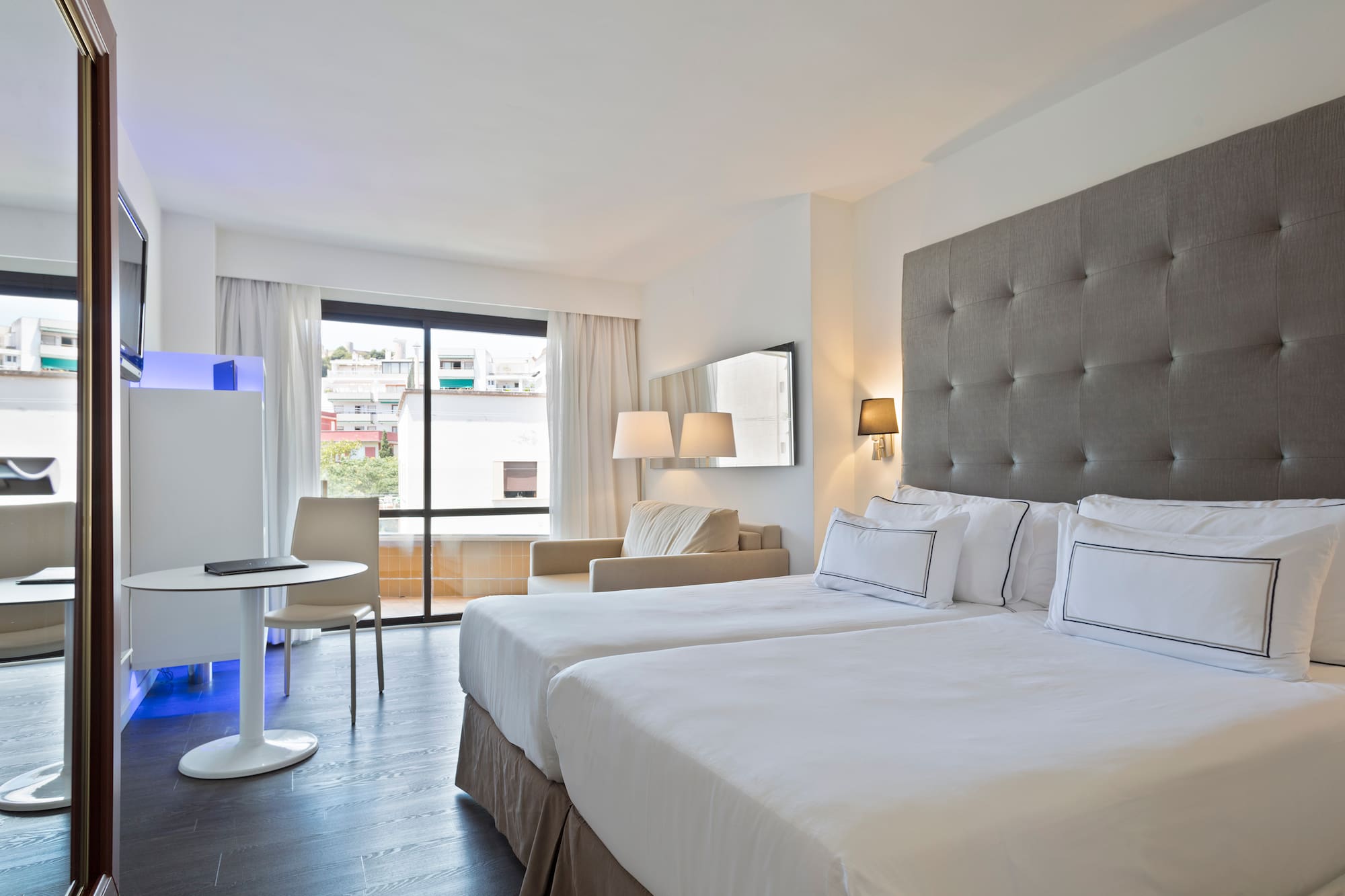 a room with two beds and a table