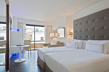 a room with two beds and a table