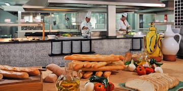 a kitchen with chef cooking in the background
