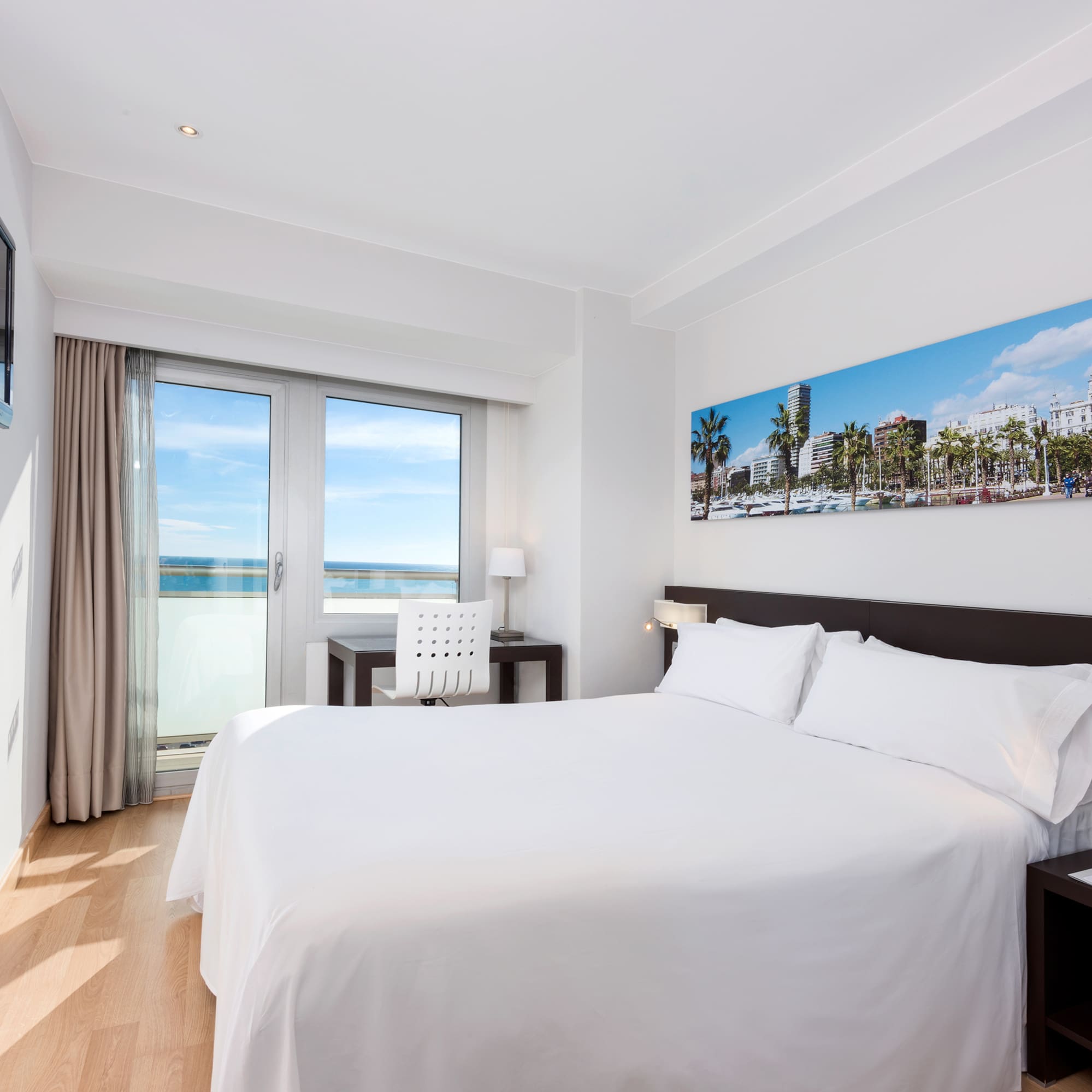 a bedroom with a bed and a table and chairs