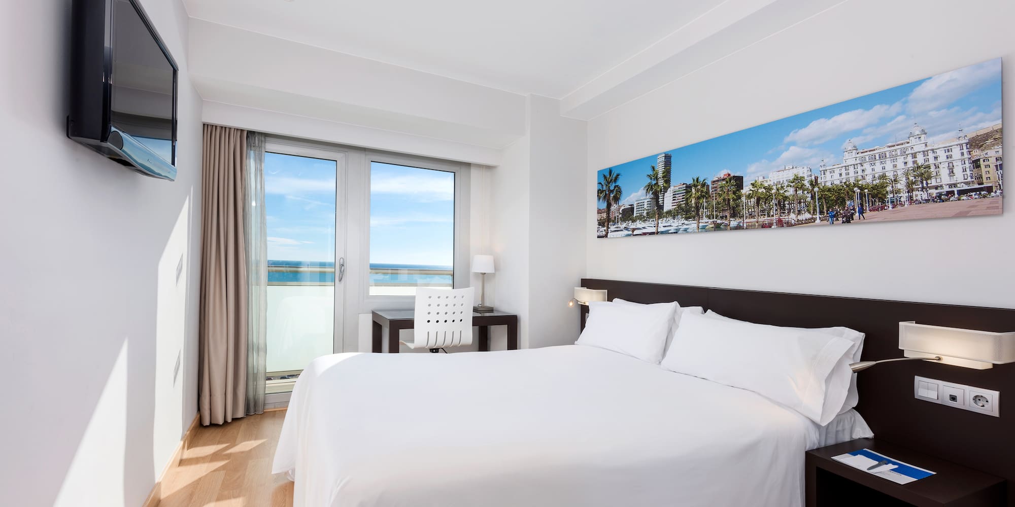 a bedroom with a bed and a table and chairs