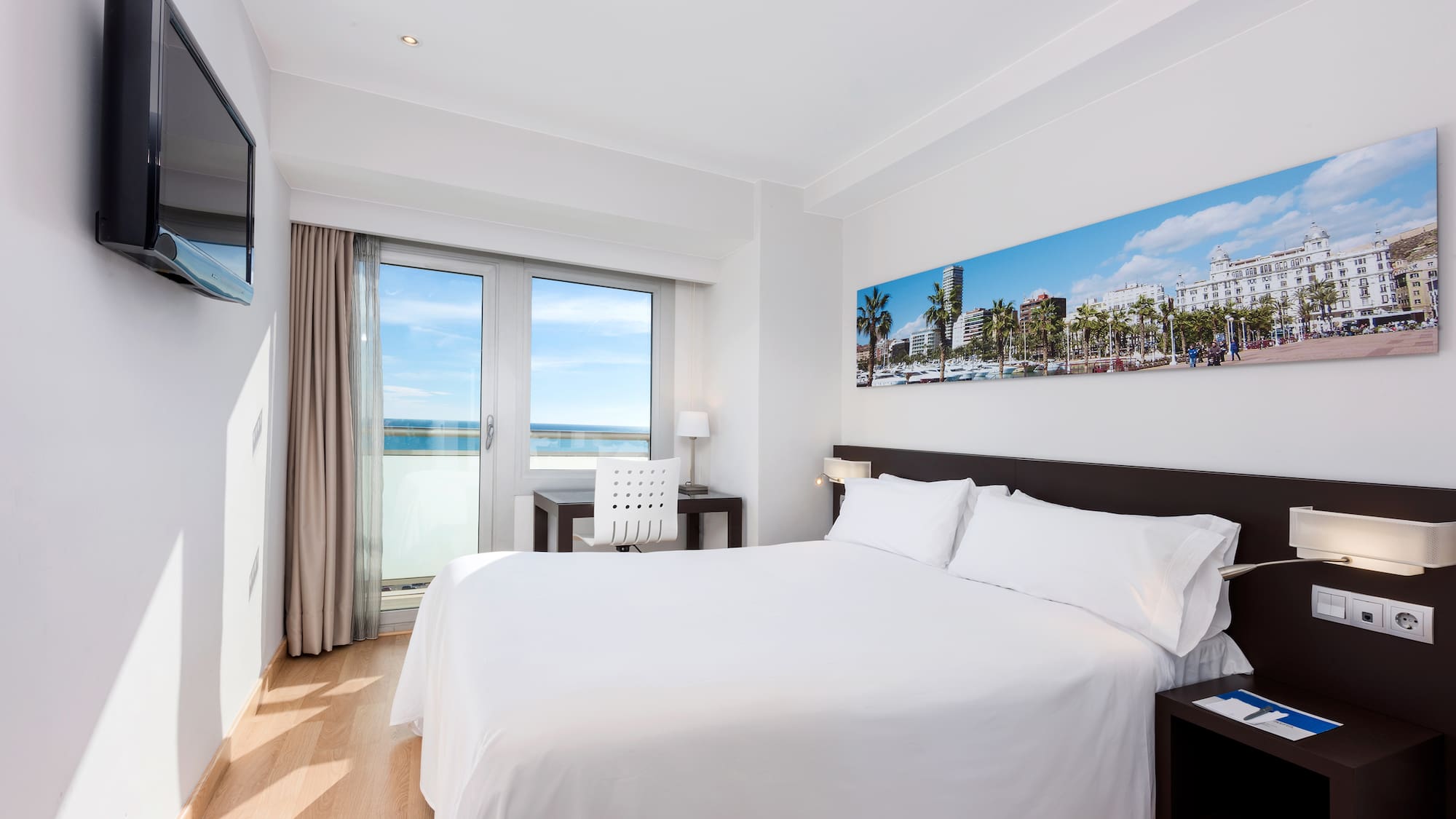 a bedroom with a bed and a table and chairs