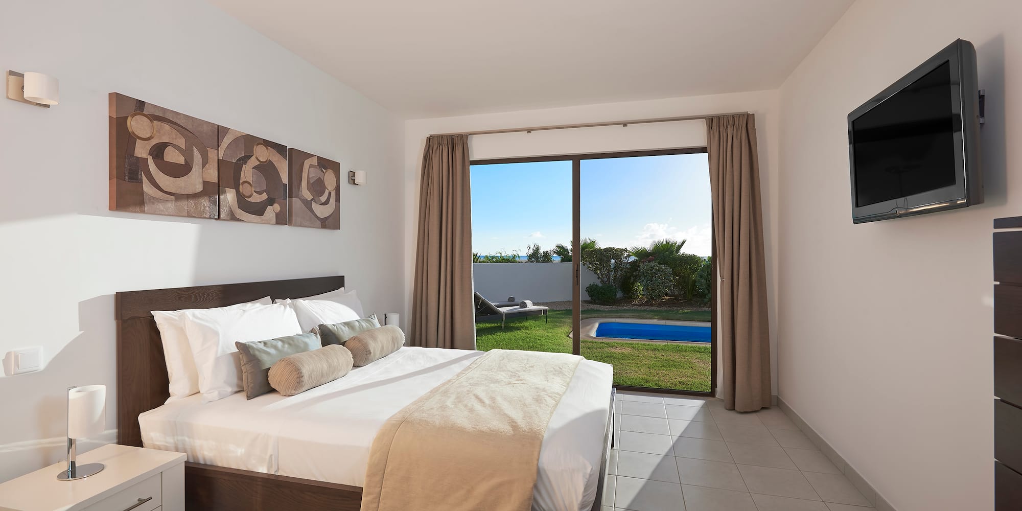 a bedroom with a large window and a bed