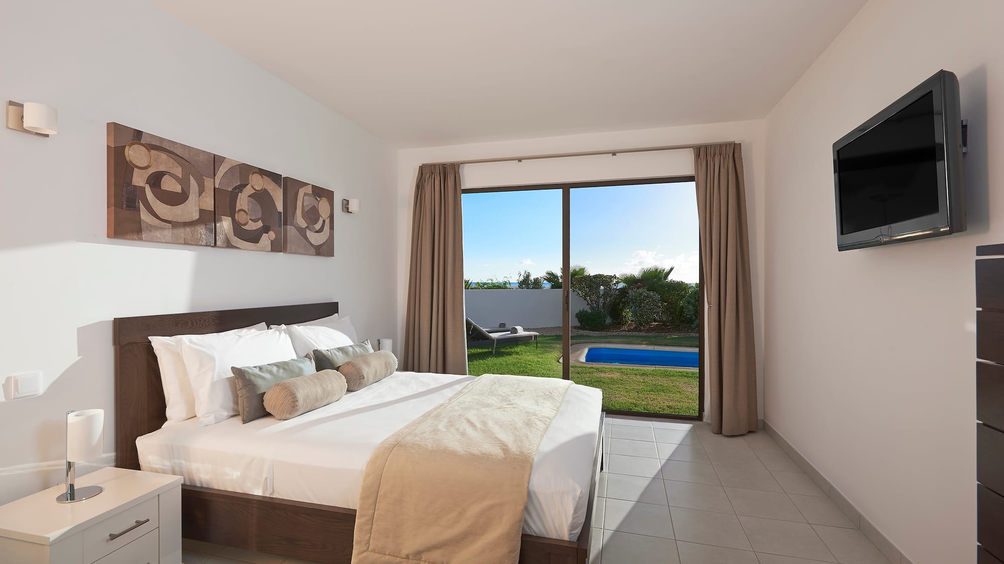 a bedroom with a large window and a bed