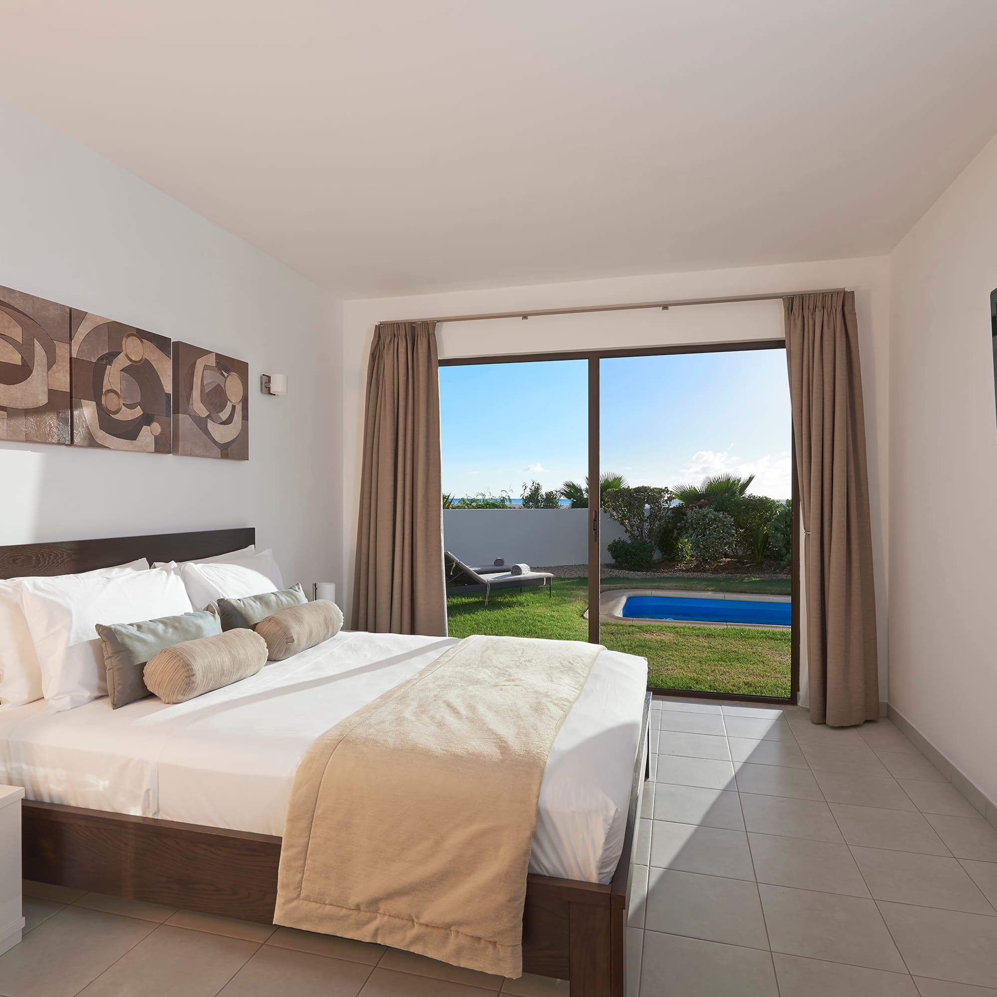 a bedroom with a large window and a bed