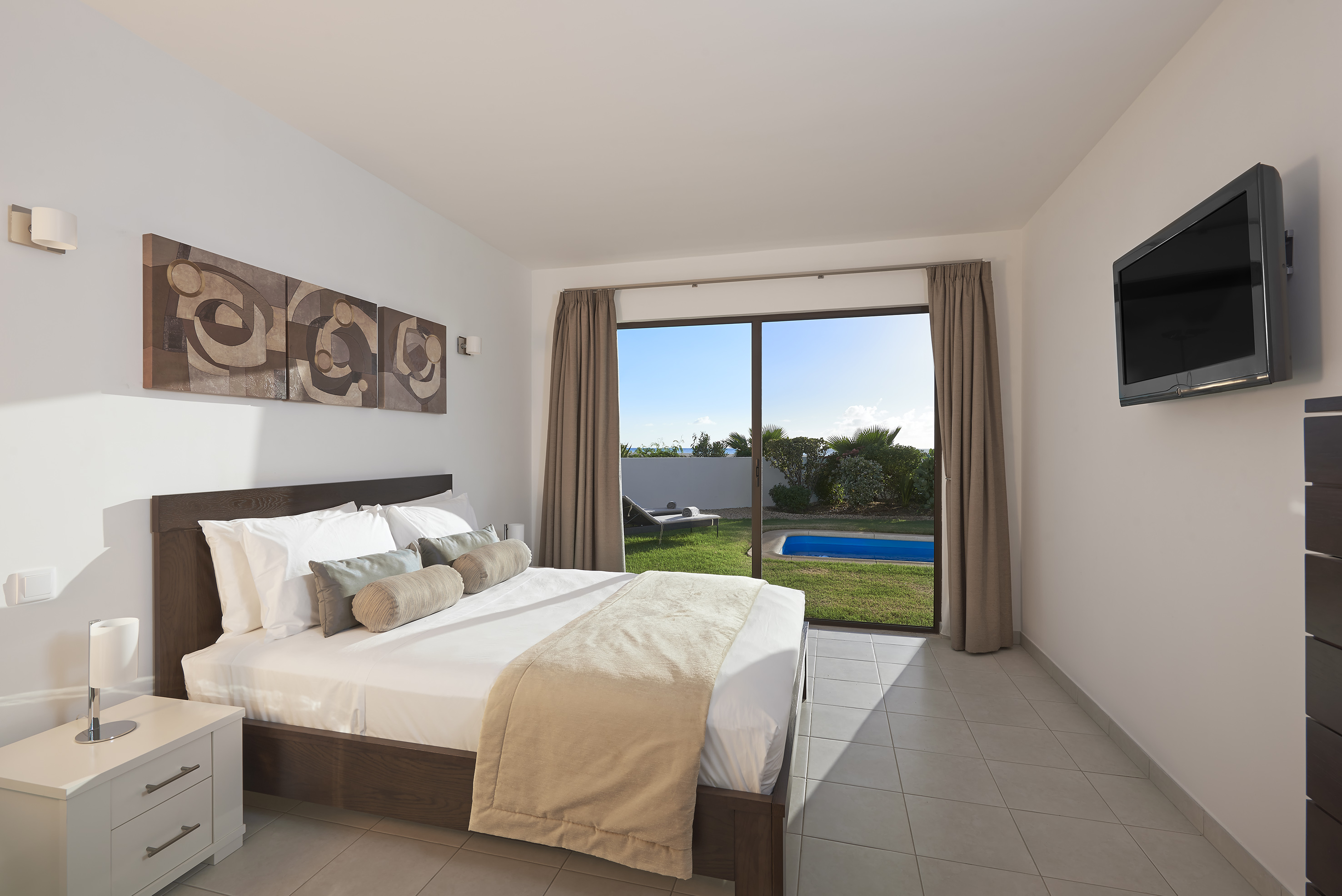 a bedroom with a large window and a bed