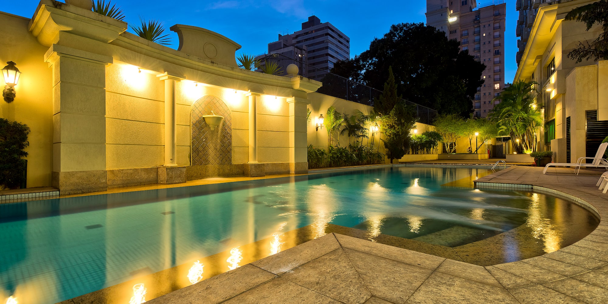 a pool with lights on the side of it