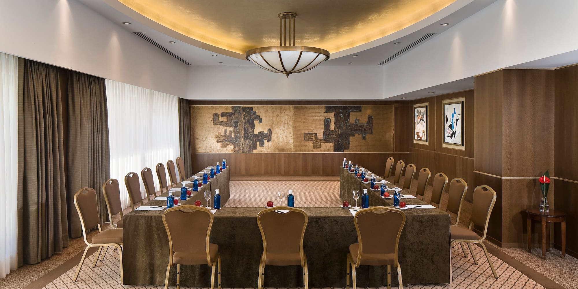 a room with a long table and chairs