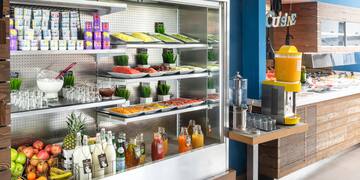 a display case with food and drinks on shelves