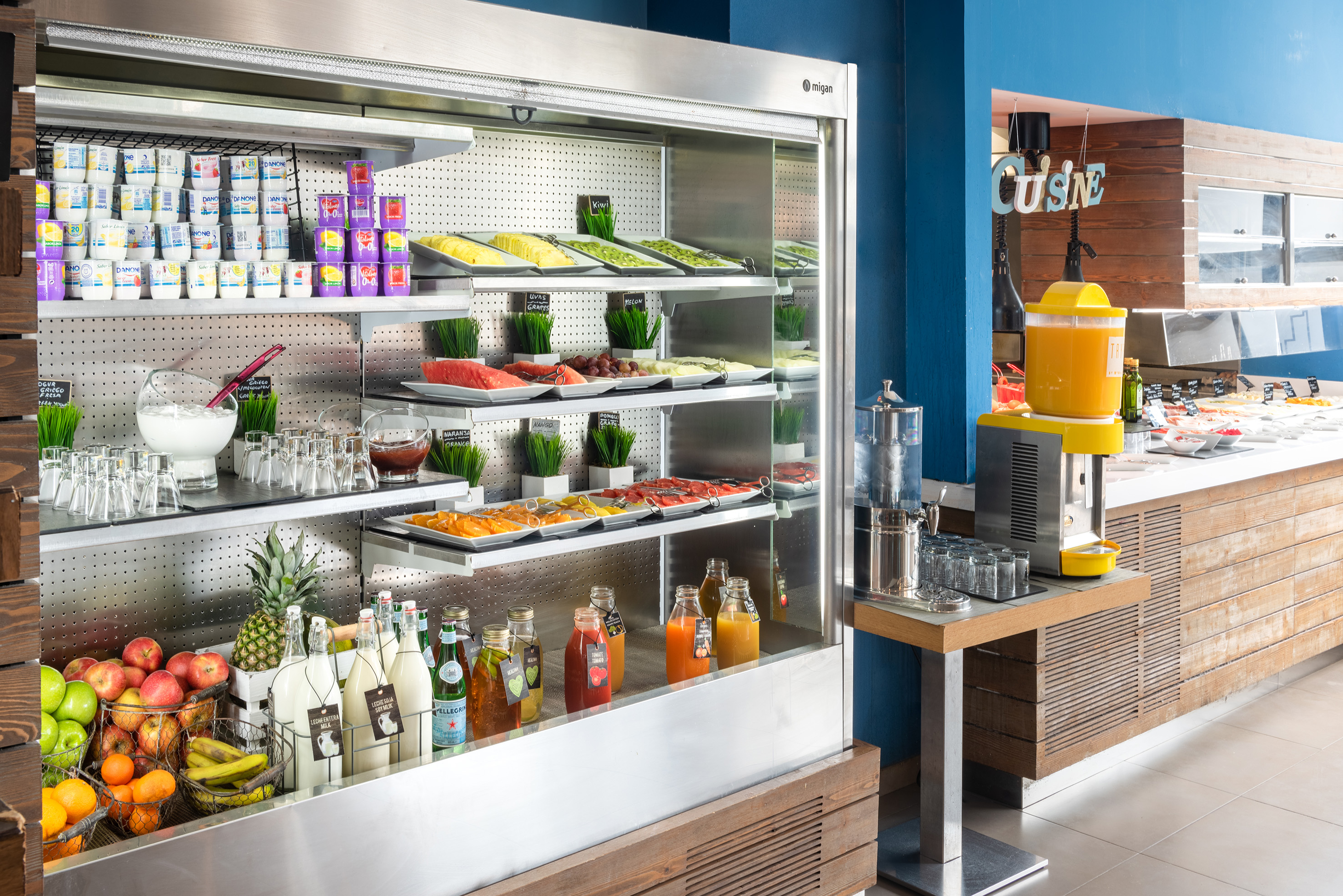 a display case with food and drinks on shelves