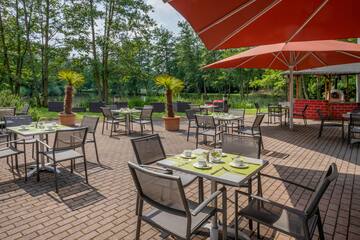 a patio with tables and chairs and umbrellas
