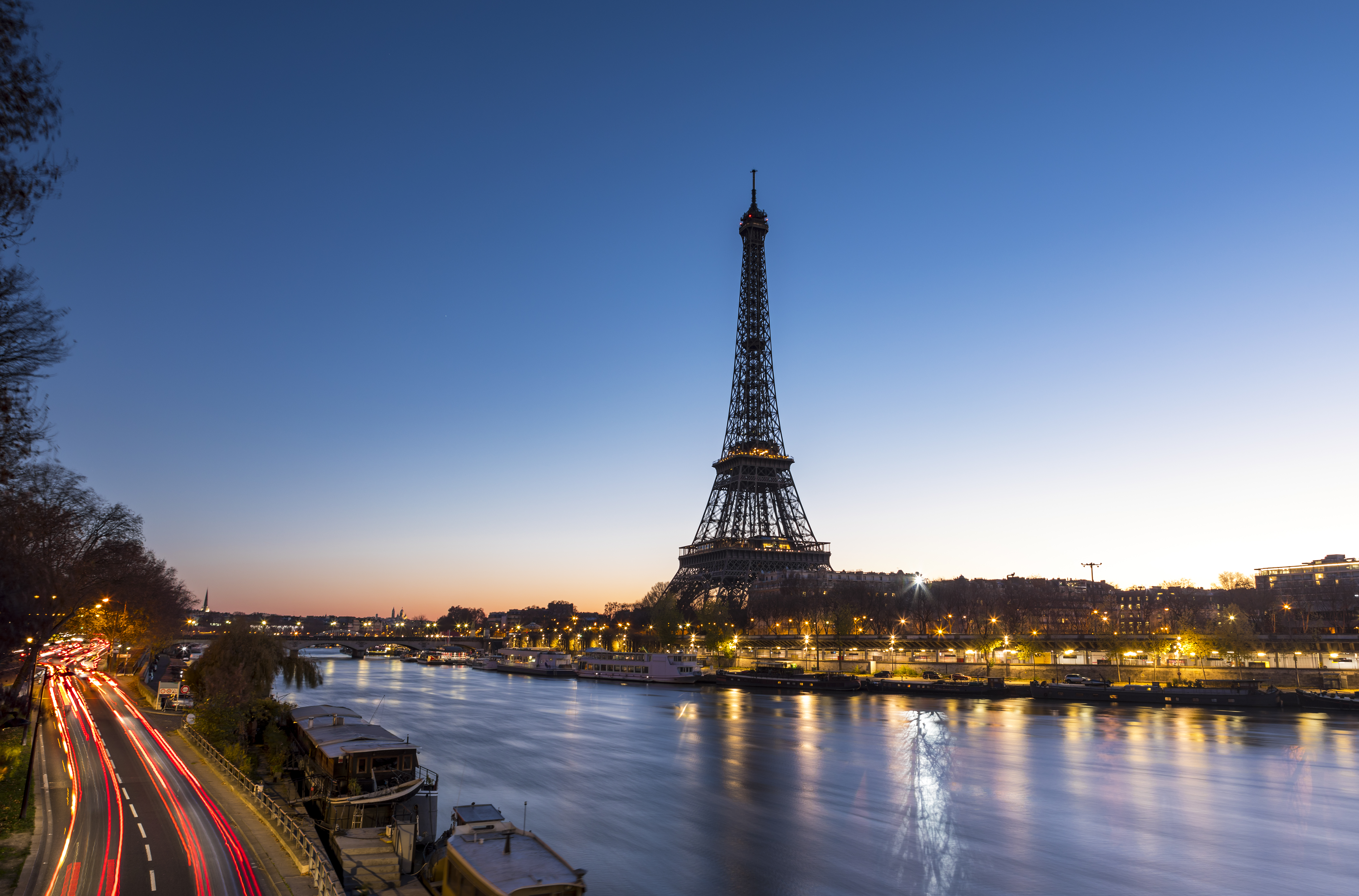 a eiffel tower and a river at night
