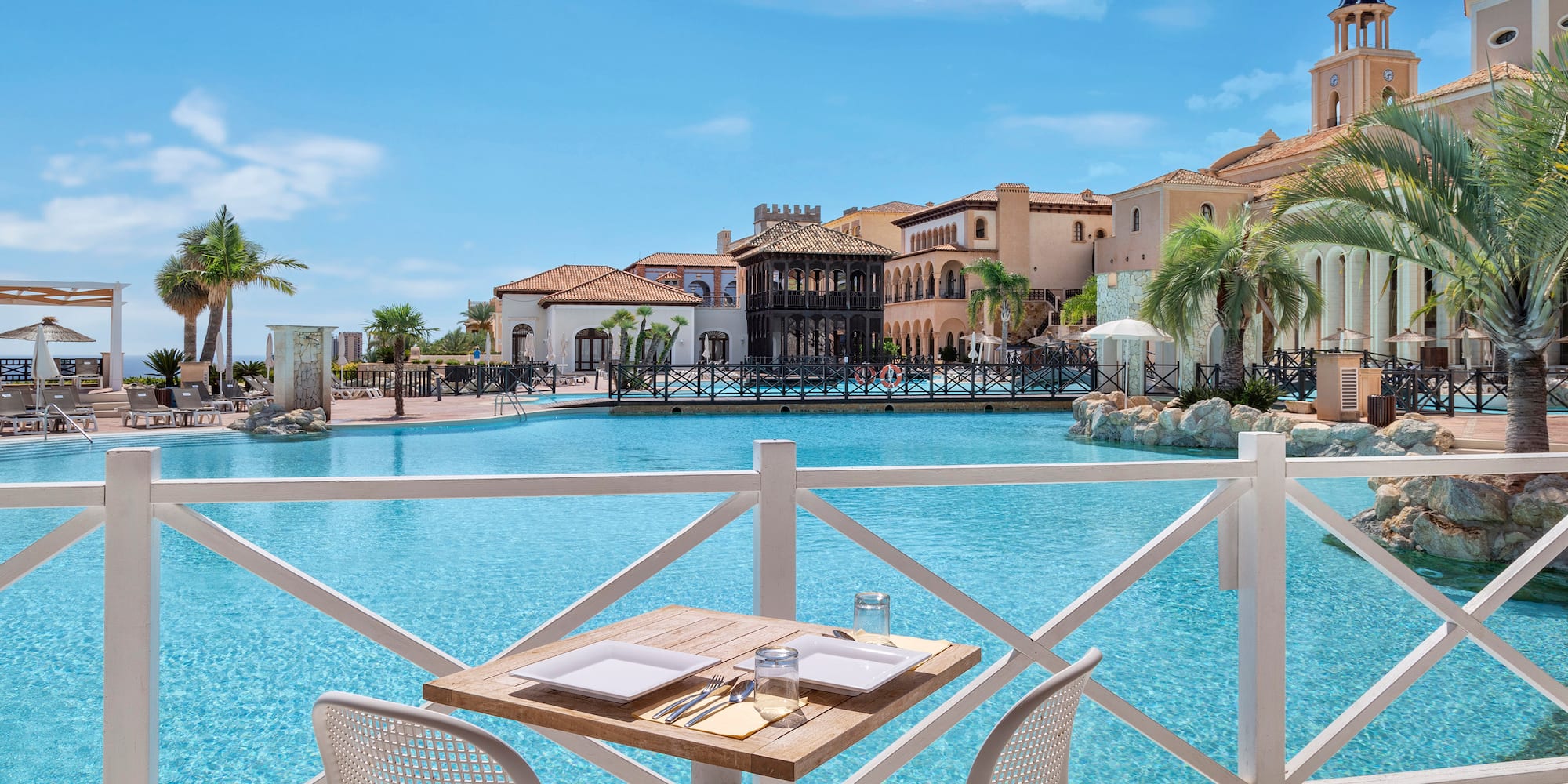a table and chairs by a pool